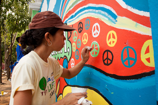 Quezon City, Philippines - June 1, 2013: An attempt to make 3,770 meters of peace mural along the major national highway in Manila, which will be considered the longest peace mural in the world surpassing the Guinness record 