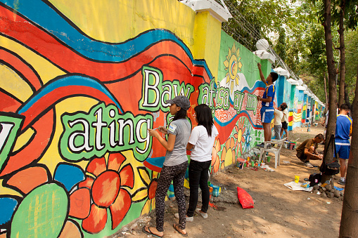 Quezon City, Philippines - June 1, 2013: An attempt to make 3,770 meters of peace mural along the major national highway in Manila, which will be considered the longest peace mural in the world surpassing the Guinness record \