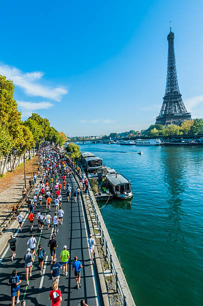 people running paris marathon france stock photo