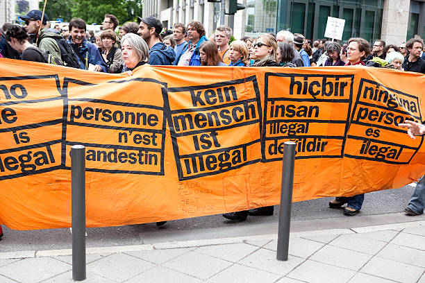 Protestors at Blockupy 2013 demonstration, Frankfurt Frankfurt, Germany - June 1, 2013: Protestors at Blockupy 2013 demonstration in the city center of Frankfurt holding up a banner. Blockupy is a left-wing political network of several organizations. The name derives from its plan for a "blockade" and the Occupy movement. protestors at blockupy 2013 demonstration frankfurt stock pictures, royalty-free photos & images