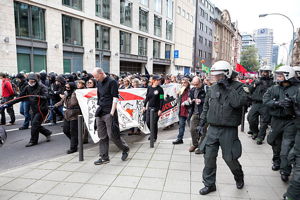 Protestors and police at Blockupy 2013 demonstration, Frankfurt Frankfurt, Germany - June 1, 2013: Protestors and anti-riot police at Blockupy 2013 demonstration in the city center of Frankfurt. Blockupy is a left-wing political network of several organizations. The name derives from its plan for a "blockade" and the Occupy movement. protestors at blockupy 2013 demonstration frankfurt stock pictures, royalty-free photos & images