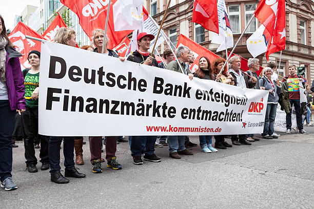 Protestors at Blockupy 2013 demonstration, Frankfurt Frankfurt, Germany - June 1, 2013: Protestors at Blockupy 2013 demonstration in the city center of Frankfurt carrying a banner. Blockupy is a left-wing political network of several organizations. The name derives from its plan for a "blockade" and the Occupy movement. protestors at blockupy 2013 demonstration frankfurt stock pictures, royalty-free photos & images