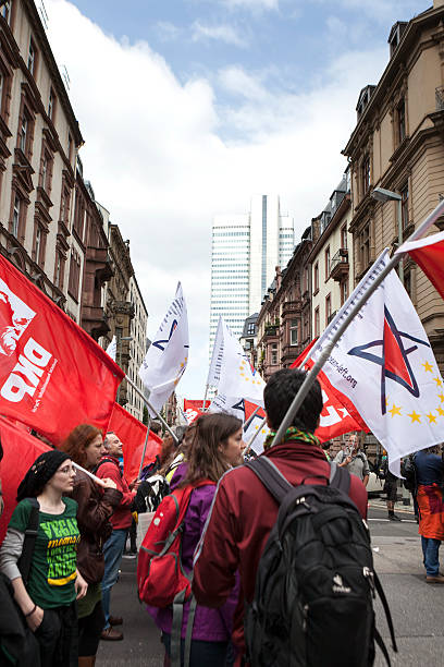 Protestors at Blockupy 2013 demonstration, Frankfurt Frankfurt, Germany - June 1, 2013: Protestors at Blockupy 2013 demonstration in the city center of Frankfurt holding up flags. Blockupy is a left-wing political network of several organizations. The name derives from its plan for a "blockade" and the Occupy movement. protestors at blockupy 2013 demonstration frankfurt stock pictures, royalty-free photos & images