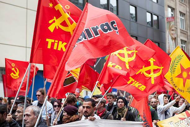 Protestors at Blockupy 2013 demonstration, Frankfurt Frankfurt, Germany - June 1, 2013: Protestors at Blockupy 2013 demonstration in the city center of Frankfurt holding up flags of TIKB. Blockupy is a left-wing political network of several organizations. The name derives from its plan for a "blockade" and the Occupy movement. protestors at blockupy 2013 demonstration frankfurt stock pictures, royalty-free photos & images
