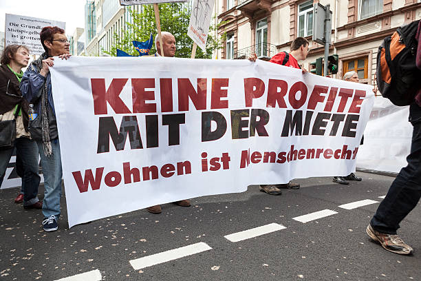Protestors at Blockupy 2013 demonstration, Frankfurt Frankfurt, Germany - June 1, 2013: Protestors at Blockupy 2013 demonstration in the city center of Frankfurt carrying a banner. Blockupy is a left-wing political network of several organizations. The name derives from its plan for a "blockade" and the Occupy movement. protestors at blockupy 2013 demonstration frankfurt stock pictures, royalty-free photos & images