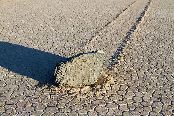 Sailing Stone at The Racetrack Playa One of the moving rocks or "sailing stones" at The Racetrack Playa, or The Racetrack, in Death Valley National Park in California.  racetrack playa stock pictures, royalty-free photos & images