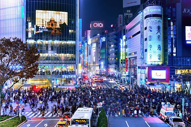 Shibuya Crossing in Tokyo, Japan Tokyo, Japan - December 15, 2012: Pedestrians cross at Shibuya Crossing. The crosswalk is one of the world's most famous implementations of a scramble crosswalk. tokyo crowds on the famous shibuya crossing japan stock pictures, royalty-free photos & images