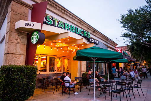 West Hollywood, USA - June 1, 2013: People sitting at Starbucks Coffee in West Hollywood, USA, located on Santa Monica Boulevard, One third of population in West Hollywood are identifying themselves as gay