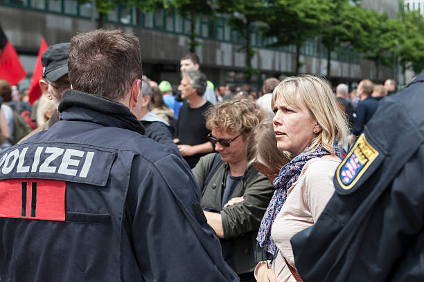 Blockupy 2013, Frankfurt Frankfurt, Germany - June 1, 2013: Participants of Blockupy 2013 demonstration ahving a discussion with riot police in the city center of Frankfurt. Blockupy is a left-wing political network of several organizations. The name derives from its plan for a "blockade" and the Occupy movement. protestors at blockupy 2013 demonstration frankfurt stock pictures, royalty-free photos & images