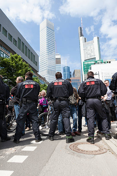 Blockupy 2013, Frankfurt Frankfurt, Germany - June 1, 2013: Protestors and anti-riot police standing face to face at Blockupy 2013 demonstration in the city center of Frankfurt. In the background some skyscrapers of the financial district. Blockupy is a left-wing political network of several organizations. The name derives from its plan for a "blockade" and the Occupy movement. protestors at blockupy 2013 demonstration frankfurt stock pictures, royalty-free photos & images