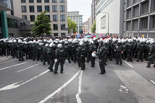 Blockupy 2013, Frankfurt Frankfurt, Germany - June 1, 2013: Protestors (in the background) and anti-riot police standing face to face at Blockupy 2013 demonstration in the city center of Frankfurt. Blockupy is a left-wing political network of several organizations. The name derives from its plan for a "blockade" and the Occupy movement. protestors at blockupy 2013 demonstration frankfurt stock pictures, royalty-free photos & images