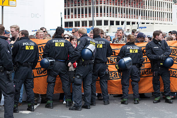 Blockupy 2013, Frankfurt Frankfurt, Germany - June 1, 2013: Protestors and anti-riot police standing face to face at Blockupy 2013 demonstration in the city center of Frankfurt. Blockupy is a left-wing political network of several organizations. The name derives from its plan for a "blockade" and the Occupy movement. riot police stock pictures, royalty-free photos & images