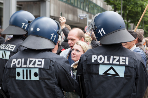 Frankfurt, Germany - June 1, 2013: Protestors and anti-riot police standing face to face at Blockupy 2013 demonstration in the city center of Frankfurt. Blockupy is a left-wing political network of several organizations. The name derives from its plan for a \