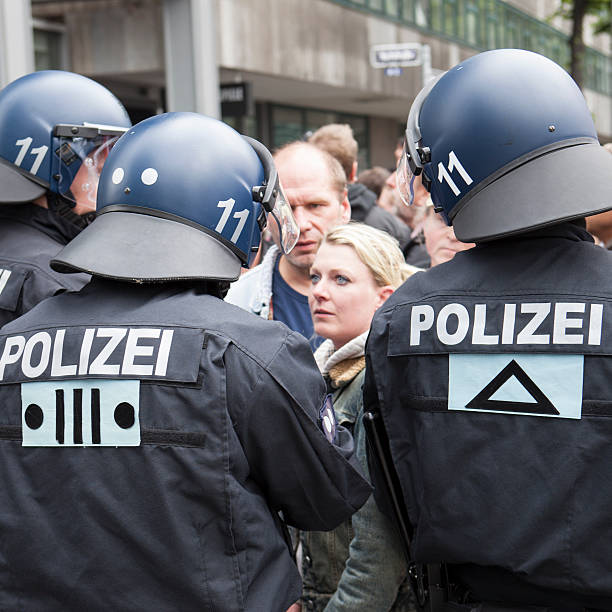 Blockupy 2013, Frankfurt Frankfurt, Germany - June 1, 2013: Protestors and anti-riot police standing face to face at Blockupy 2013 demonstration in the city center of Frankfurt. Blockupy is a left-wing political network of several organizations. The name derives from its plan for a "blockade" and the Occupy movement. protestors at blockupy 2013 demonstration frankfurt stock pictures, royalty-free photos & images