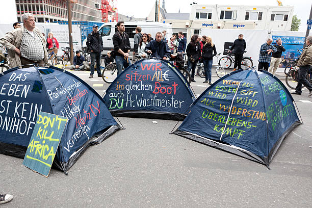 Blockupy demonstration 2013, Frankfurt Frankfurt, Germany - June 1, 2013: Tents with political slogans at Blockupy 2013 demonstration in the city center of Frankfurt. In the background some protestors. Blockupy is a left-wing political network of several organizations. The name derives from its plan for a "blockade" and the Occupy movement. protestors at blockupy 2013 demonstration frankfurt stock pictures, royalty-free photos & images