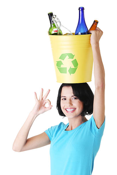 istock Young casual woman holding bin on her head. 471549379