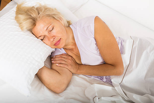 istock Middle-aged woman sleeping in bed 471550150