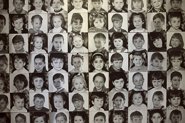 Kiev, Ukraine - May 23, 2013: Photos of Children who were  born after the Chernobyl nuclear disaster in 1987-1988 in the families of liquidators of the accident and evacuated from Pripyat and Chernobyl.These portraits are now displayed on a memorial wall at Chernobyl museum in Kiev.