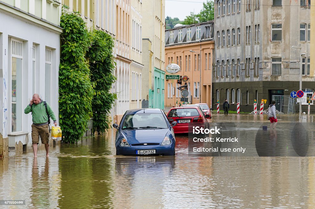 high water "flood of the century" June 2013 Gera, Germany Gera, Germany - June 3, 2013: The "flood of the century" in June 2013 - Gera, Germany. In June 2013 after a lot of rain had germany a flood of the century, higher then the flood of 2002. Here the photos of Gera, Thuringia. After the peak of the flood. Photo taken in the street Oststrasse near the river weisse Elster. People walking trough the flood. Germany Stock Photo