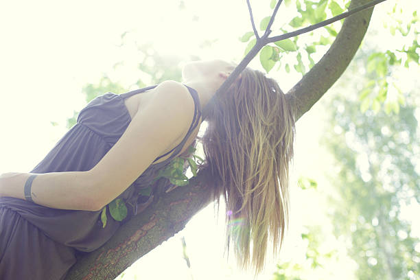 istock Girl on the tree 471550520