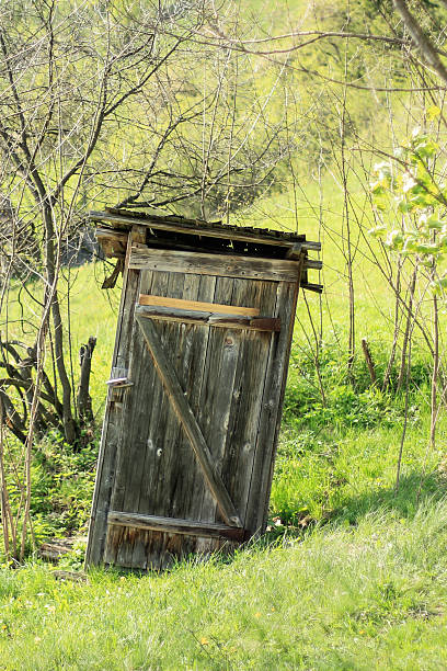 Old battered outhouse stock photo