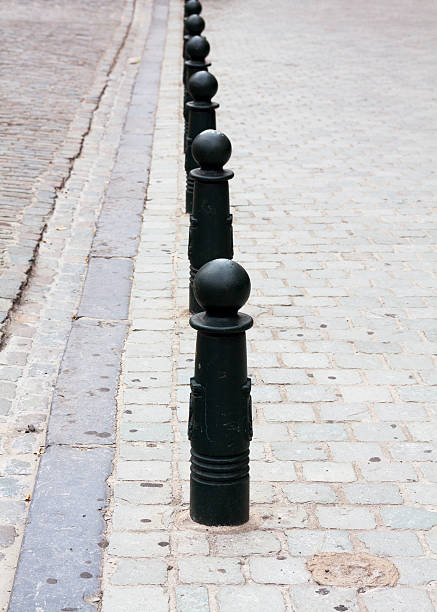 istock Row of metal poles on sidewalk 471552260