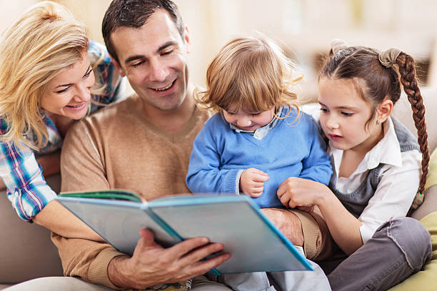 istock Smiling family reading a story at home. 471552588