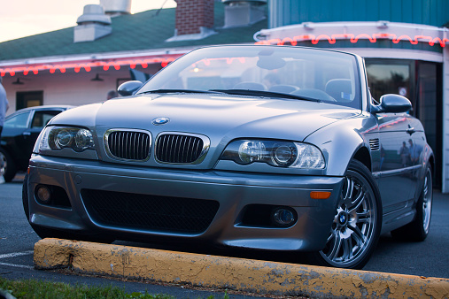 Bedford, Nova Scotia, Canada - June 4, 2013: A BMW M3 E46 convertible while parked in a parking lot.  Wheel is parked in front of Chickenburger restaurant in Bedford, Nova Scotia.  The E46 M3 was first introduced in 2000 and features 333 HP from a 3.2 litre engine.  The BMW M3 is considered one of the best sports cars of all time and is a benchmark in sports performance.