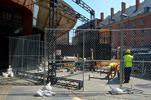 New York City, USA - May 21, 2013: Construction workers are building the Fulton Stall Market along Fulton Street for retail businesses in the South Street Seaport-Fulton Market area.