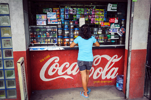 Cebu, Philippines - January 7, 2013: A woman at a conveniece store, locally known as a sari-sari, on Bacalso Avenue in Cebu City, Philippines, Asia.