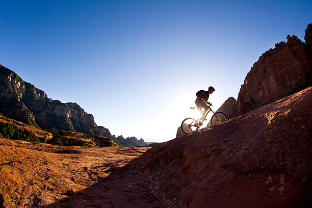 Mountain Biking in Sedona A male mountain biker rides a popular cross country trail in Sedona, Arizona, USA. red rocks state park arizona photos stock pictures, royalty-free photos & images