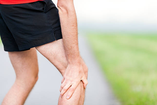 istock Runner leg and muscle pain during running training outdoors 471554329