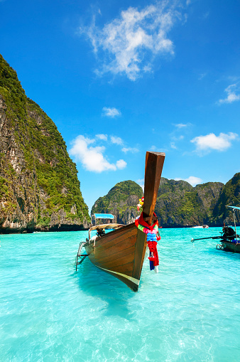Long tail wooden boat at Maya Bay on Ko Phi Phi Le, made famous by the movie titled \