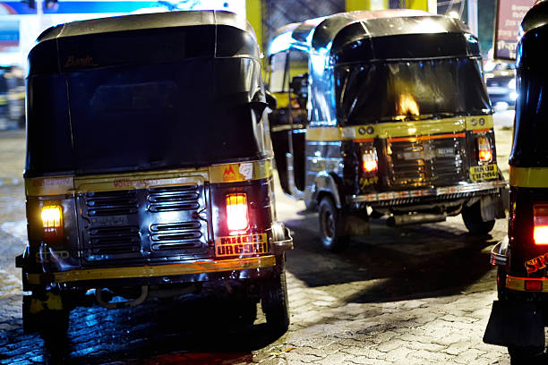 Mumbai, India - November 4, 2010: Autorickshaws in action at night in Mumbai on cobblestone streets