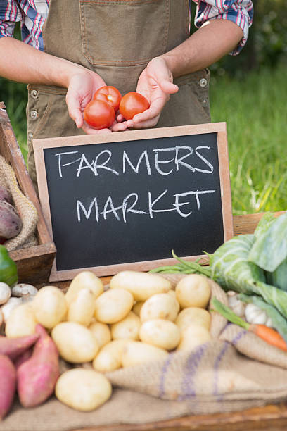 istock Farmer selling organic veg at market 471556808