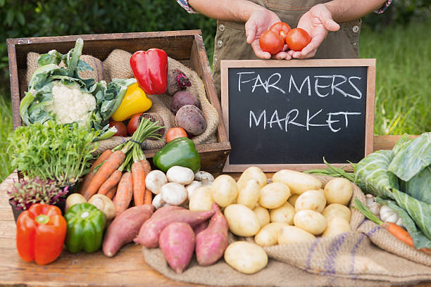 istock Farmer selling organic veg at market 471556848