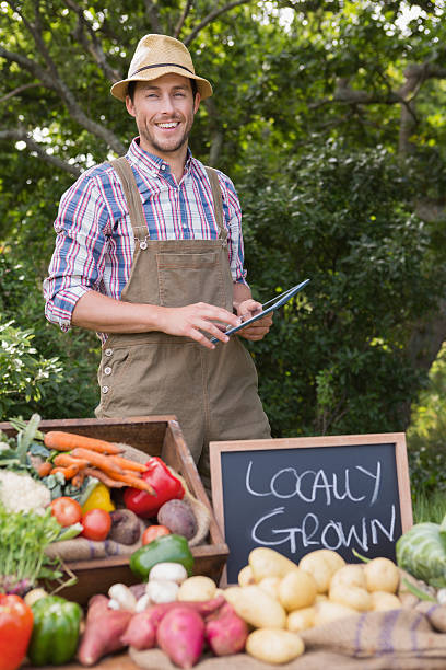istock Farmer selling organic veg at market 471556882
