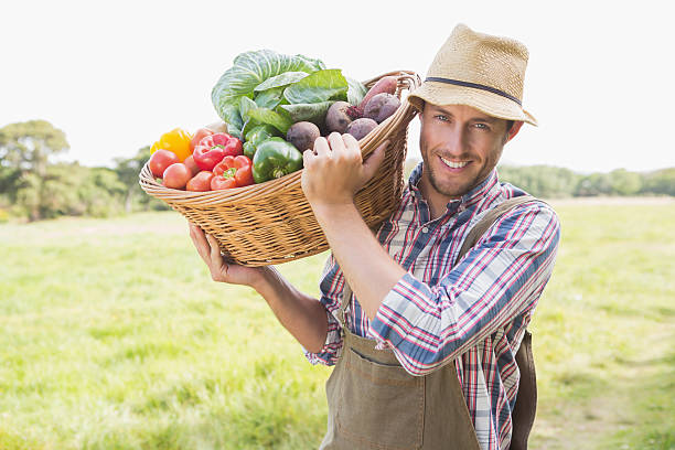 istock Farmer carrying basket of veg 471556938
