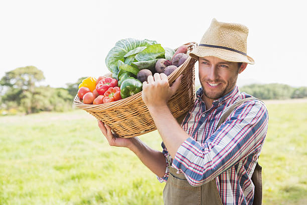 istock Farmer carrying basket of veg 471556942
