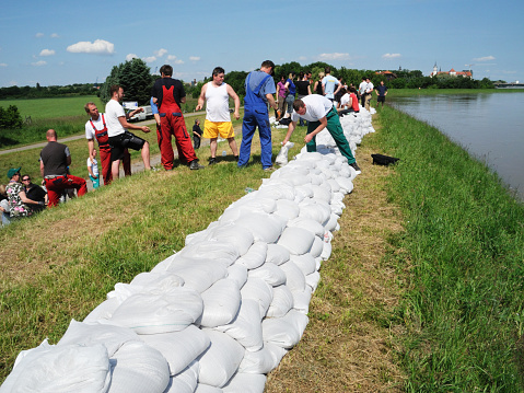 Large white bags made of synthetic fabric filled with sand to strengthen the shore