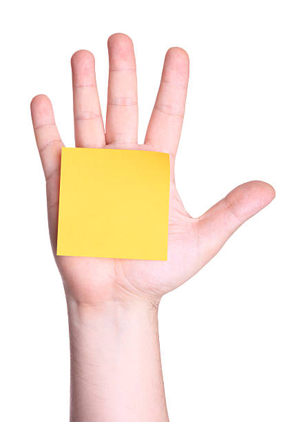 amarelo em branco nota na palma da mão - hand sign index finger human finger human thumb imagens e fotografias de stock