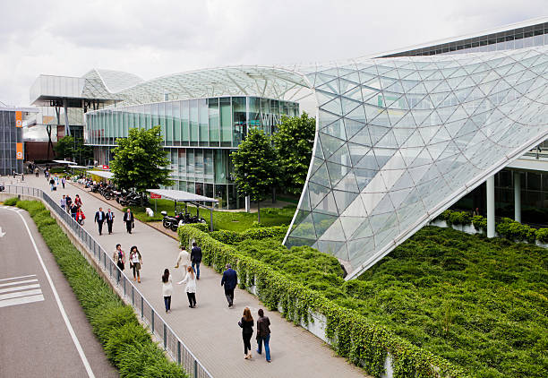 Milan, Italy - May 21, 2013: panoramic view of Fieramilano modern building with people walking on the footpath