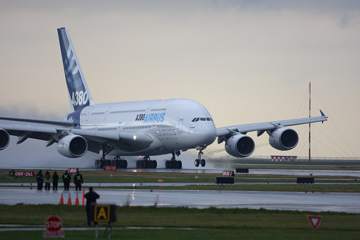 Vancouver, Canada - October 17, 2007: Airbus Industries A380 on its takeoff roll from Vancouver International Airport during its flight testing phase.  Crowds of people and airport workers came out to view the double decker airliner during its visit to Vancouver.