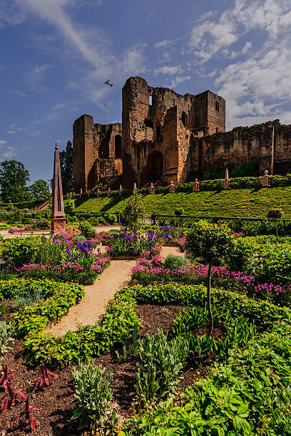 kenilworth castle Kenilworth, UK - June 7, 2013: These are the restored Elizabethan gardens at the popular tourist attraction of Kenilworth Castle in the county of Warwickshire in the English Midlands, England, UK. The gardens have been restored in the Elizabethan style with plants and flowers appropriate to that era. It is polar for people to visit. It is a warm sunny sunny day in Summer.  kenilworth castle stock pictures, royalty-free photos & images
