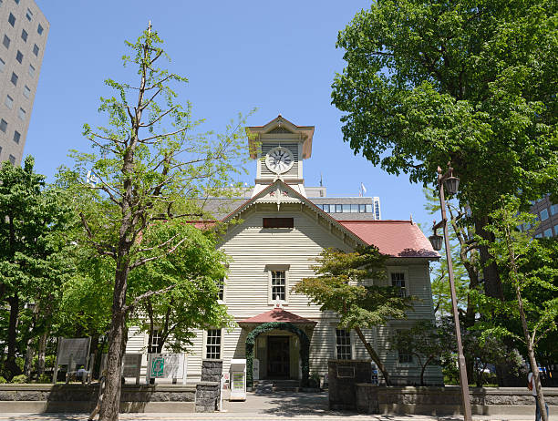 Sapporo, Japan - June 9, 2013 : Sapporo Clock Tower and fresh green leaves in the city of Sapporo, Hokkaido, Japan. It is located at center of Sapporo and a famous tourist attraction.