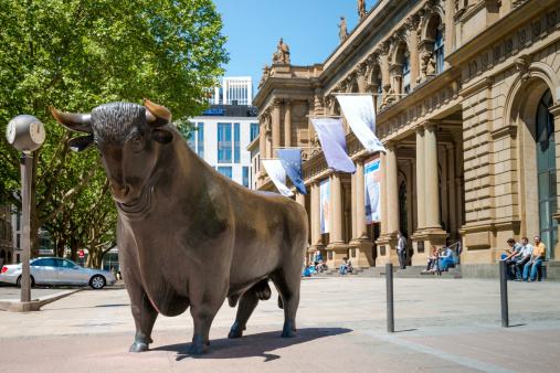Frankfurt, Germany - June 6, 2013: Main entrance of the Frankfurt stock exchange of the Deutsche Boerse AG. The historic building is located in the city center. The bull in front of the Exchange