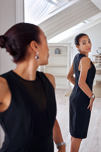 young professional business woman checking elegant dress in mirror reflection at home bedroom