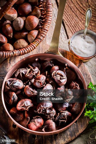 Roasted Chestnuts With Parsley Stock Photo - Download Image Now - 2015, Autumn, Brown