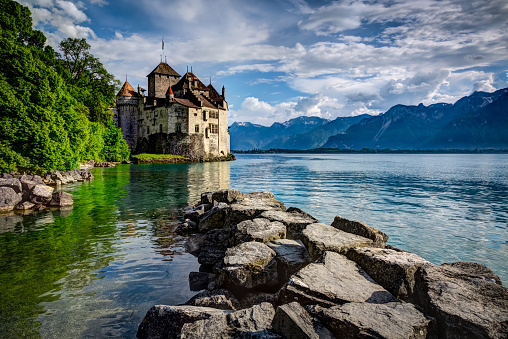Montreux, Switzerland - June 5, 2013: Chateau Chillon, Montreux, Switzerland.  The Chateau de Chillon (Chillon Castle) is located on the shore of Lake Leman, at the eastern end of the lake, 3km from Montreux, Switzerland. The castle consists of 100 independent buildings that were gradually connected to become the building as it stands now.
