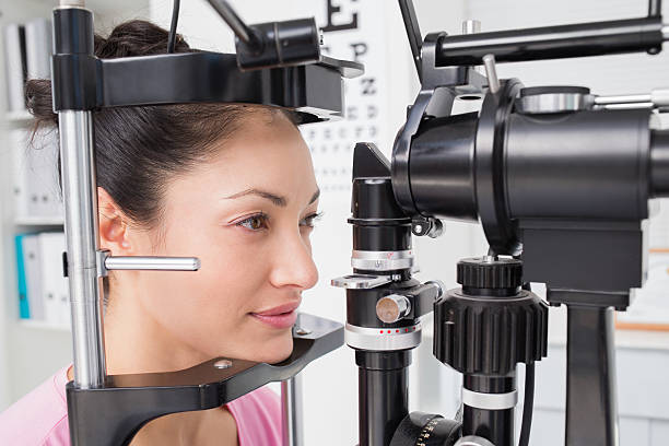 istock Female patient looking into slit lamp 471562740